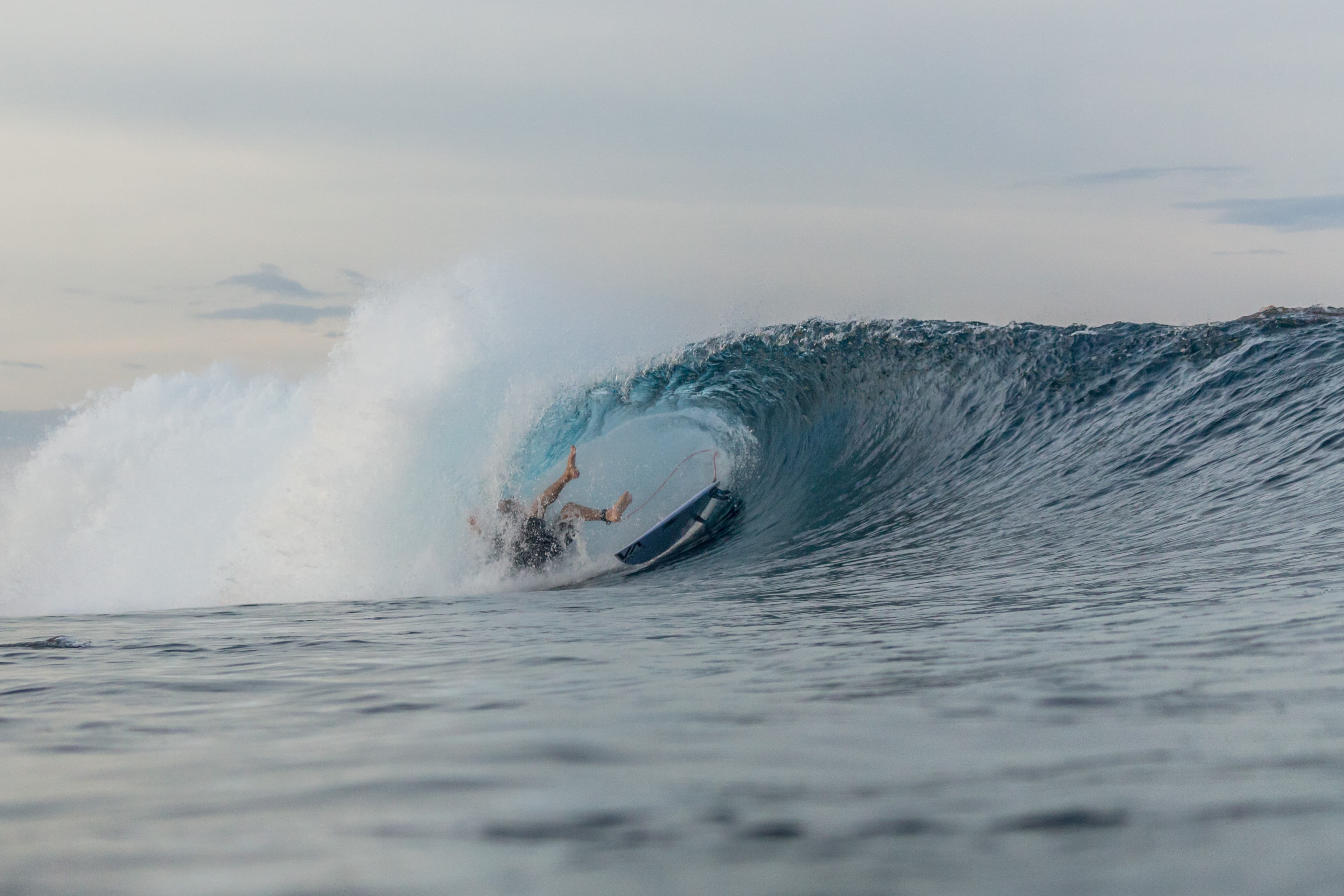 Surfer getting barelled at Tuason in Siargao, Philippines.